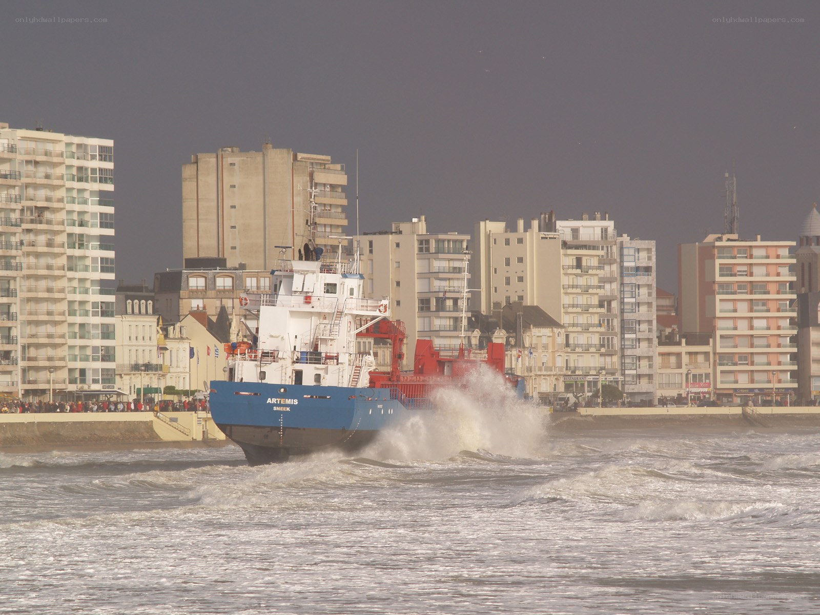 Ship in coastal city harbor