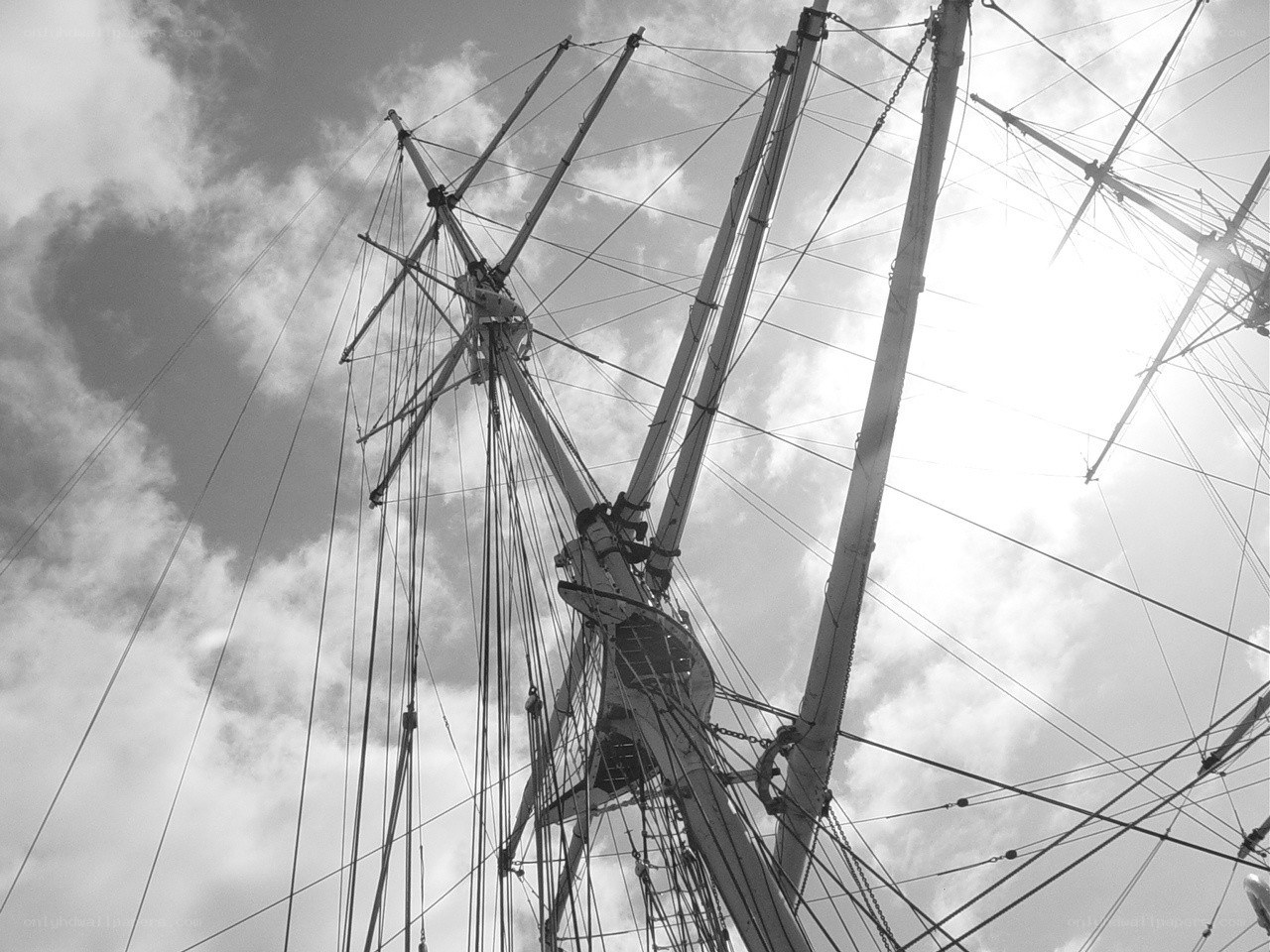 ship masts against cloudy sky