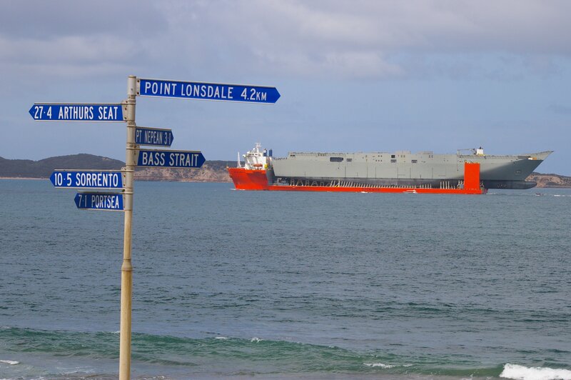 Ship near coastal signpost