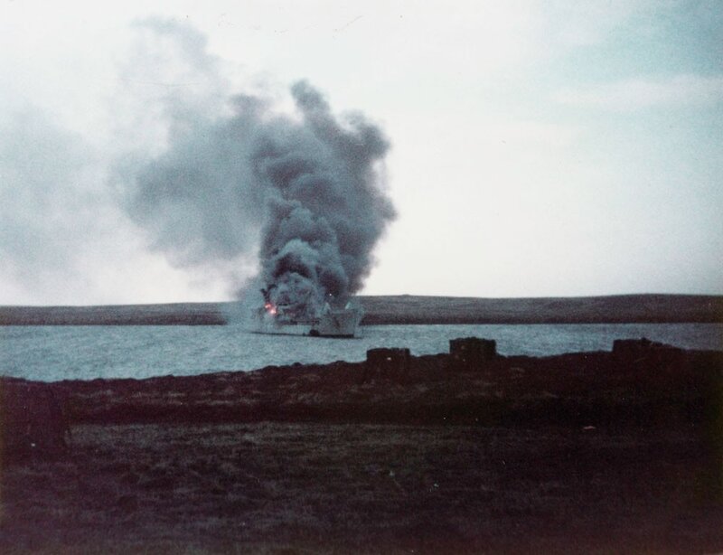 Ship on fire in a bay