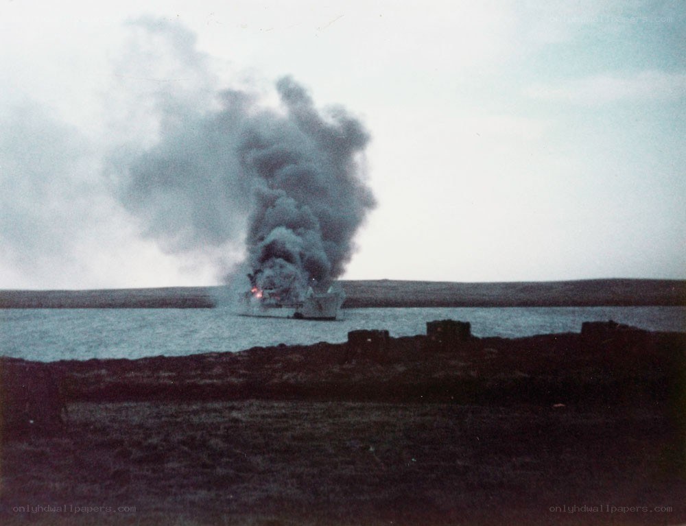 Ship on fire in a bay