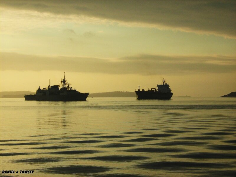 Ships at sunset on calm water