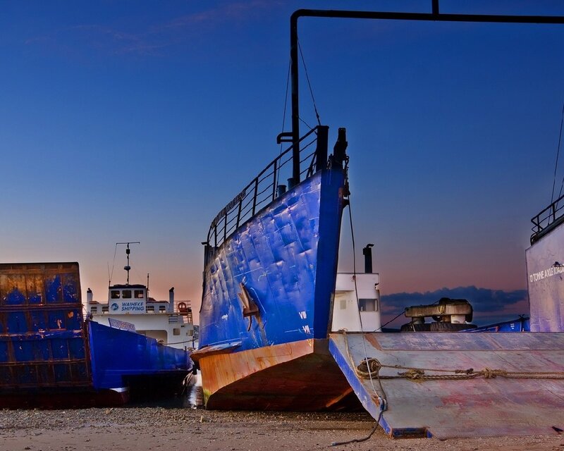 ships on a beach at dusk