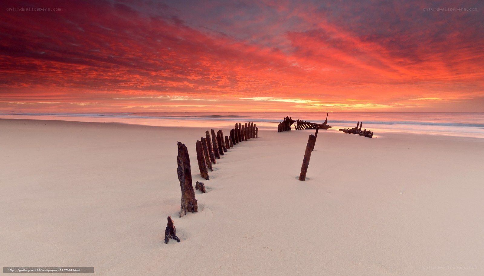 Shipwreck at sunset on a beach
