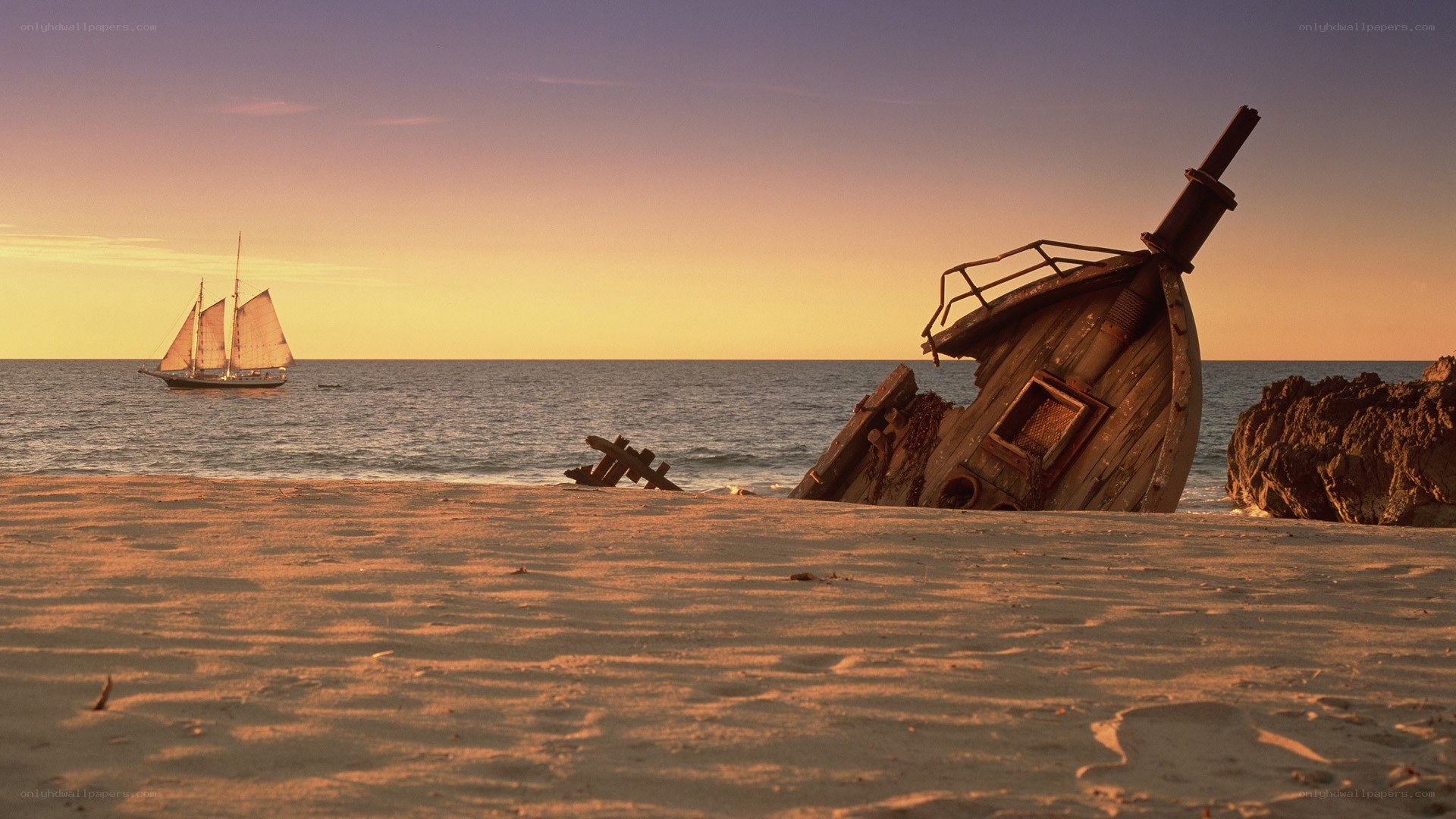 shipwreck at sunset on beach