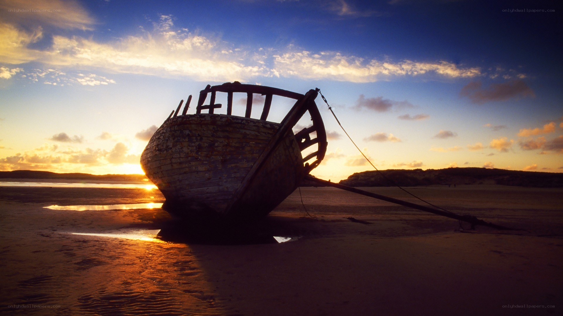 shipwreck at sunset on beach