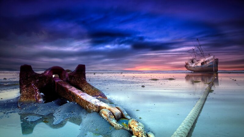 shipwreck at sunset on beach