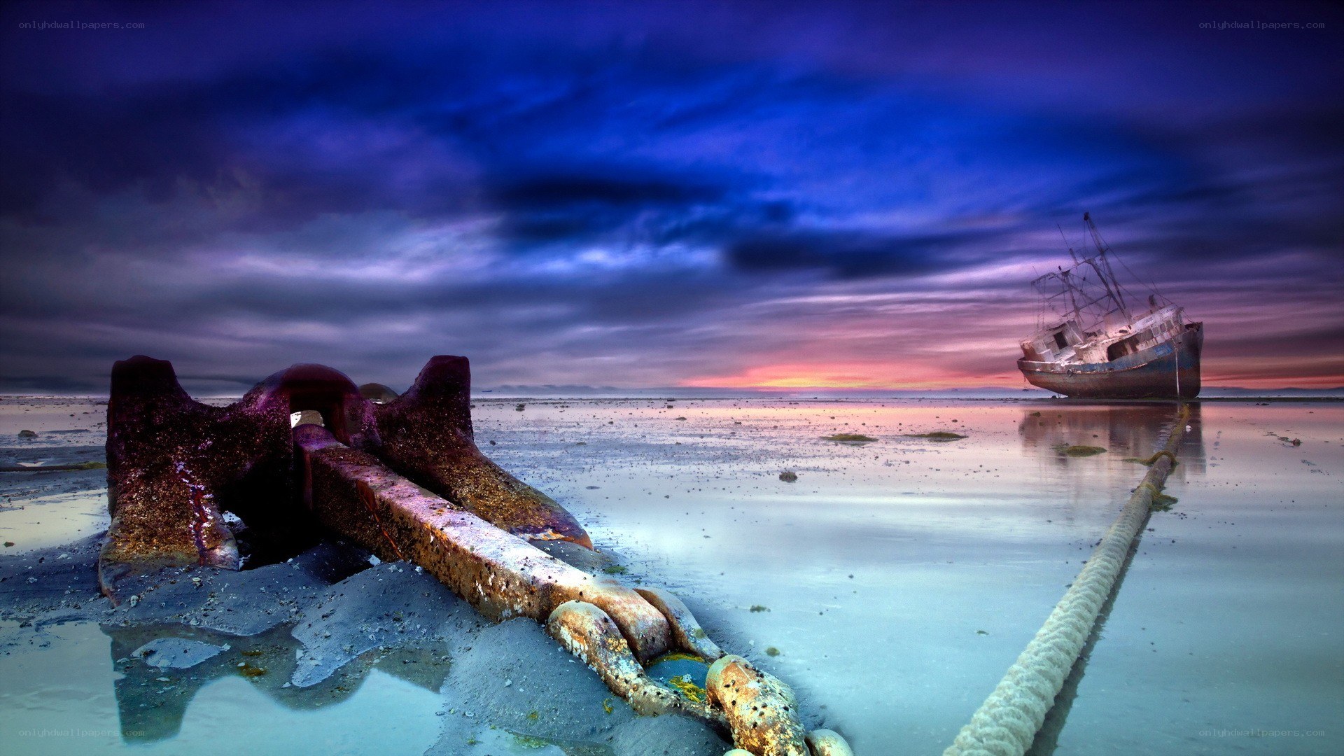 shipwreck at sunset on beach
