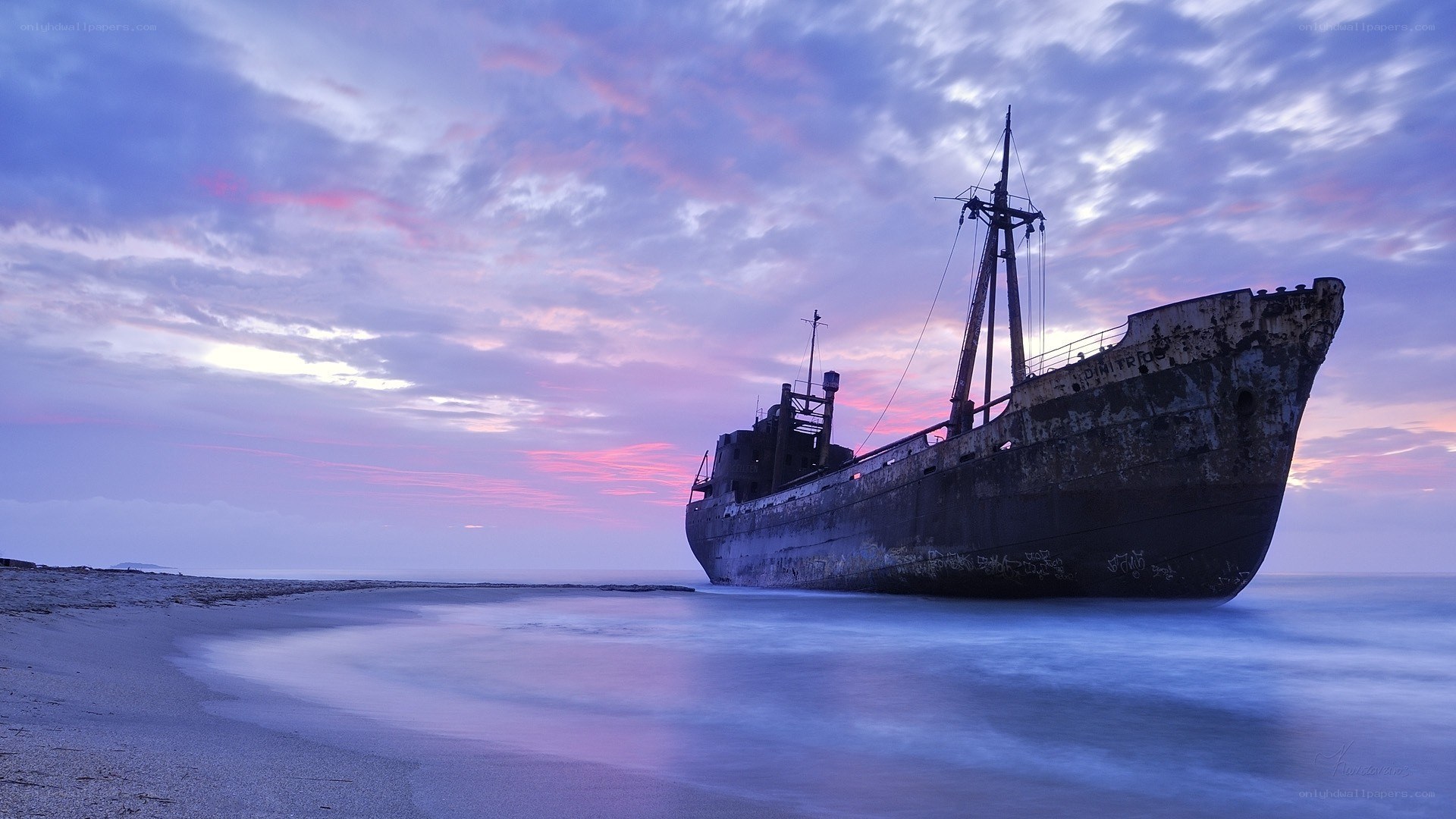 shipwreck at sunset on beach
