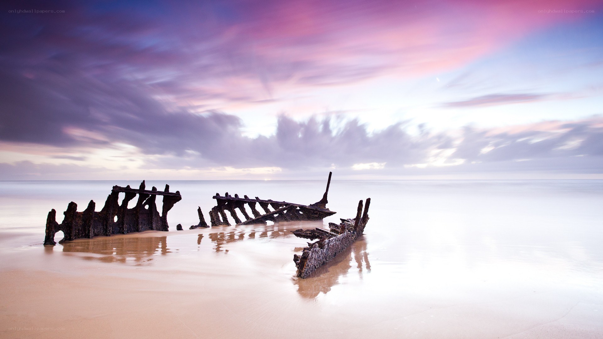 Shipwreck at sunset on the beach