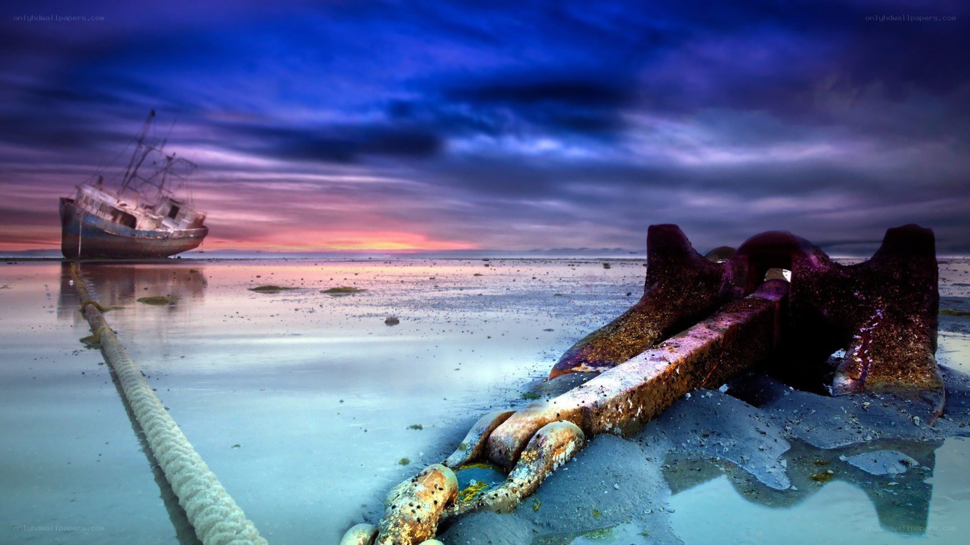 shipwreck at sunset on the shore