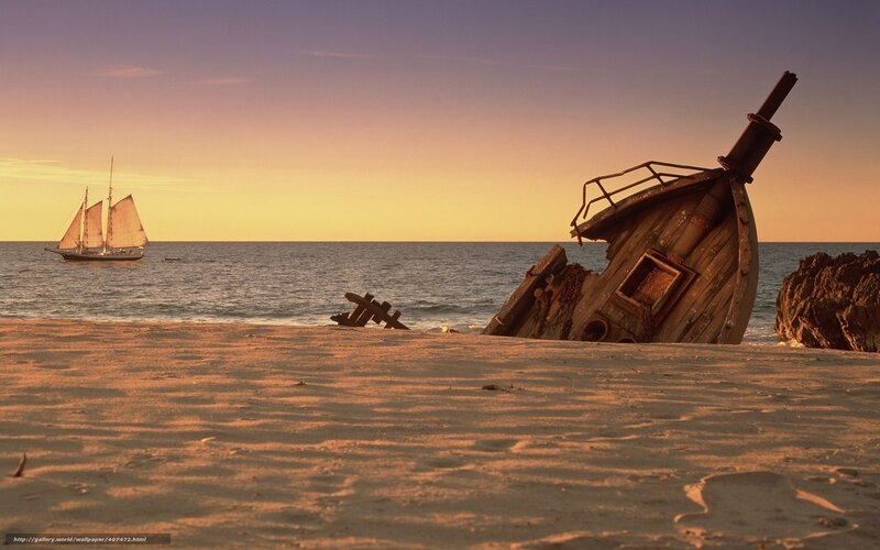 shipwreck on beach at sunset