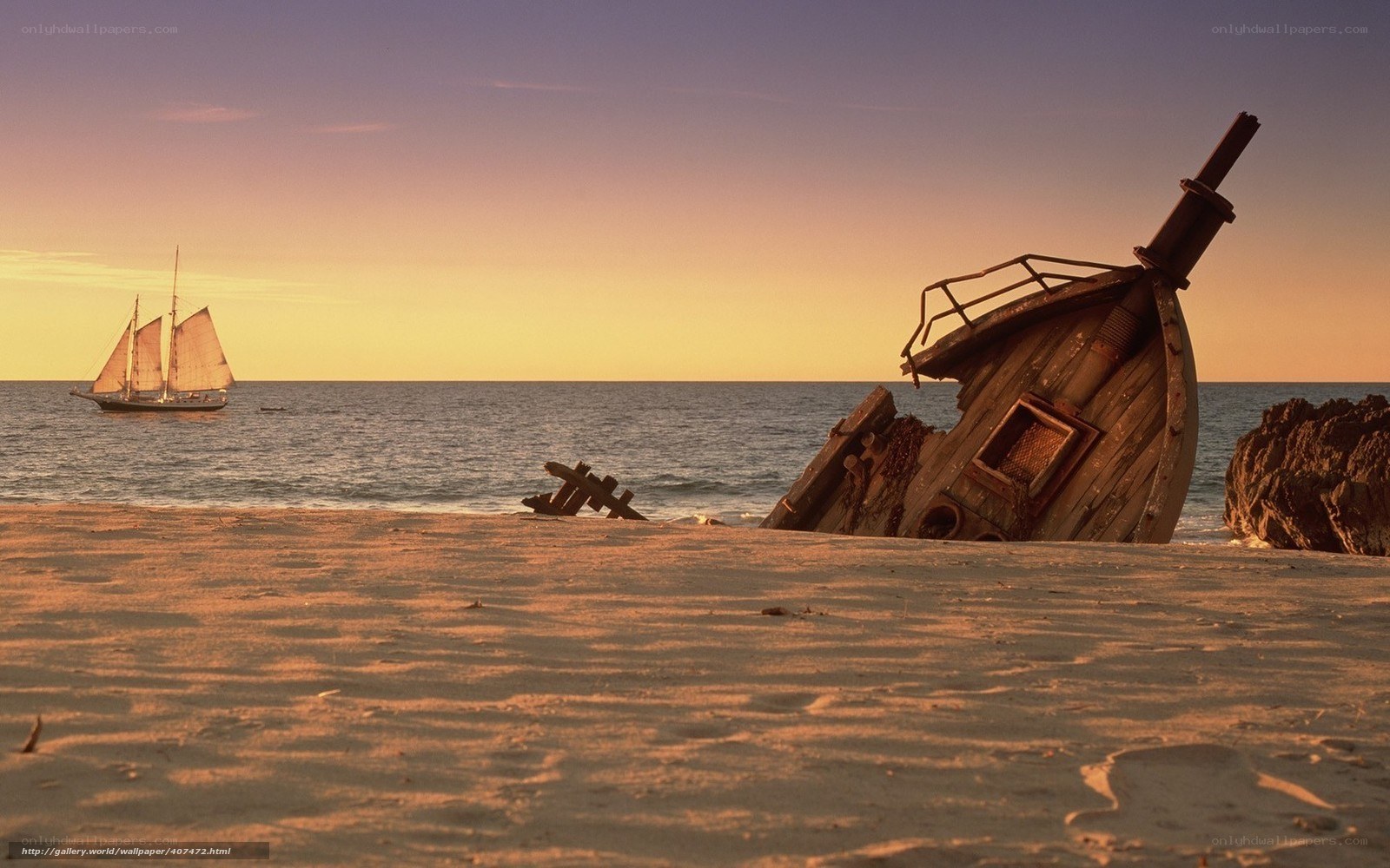 shipwreck on beach at sunset