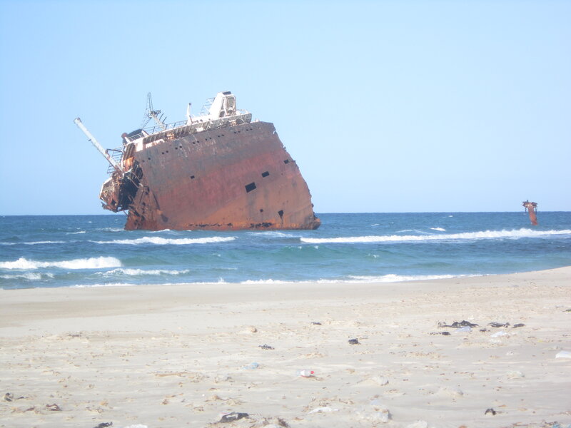 Shipwreck on Beach — Blue, Dramatic, Afternoon, Photograph