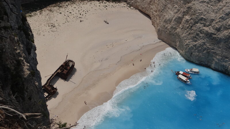 Shipwreck on Beach — Blue, Serene, Afternoon, Photograph, Boat, Cliff