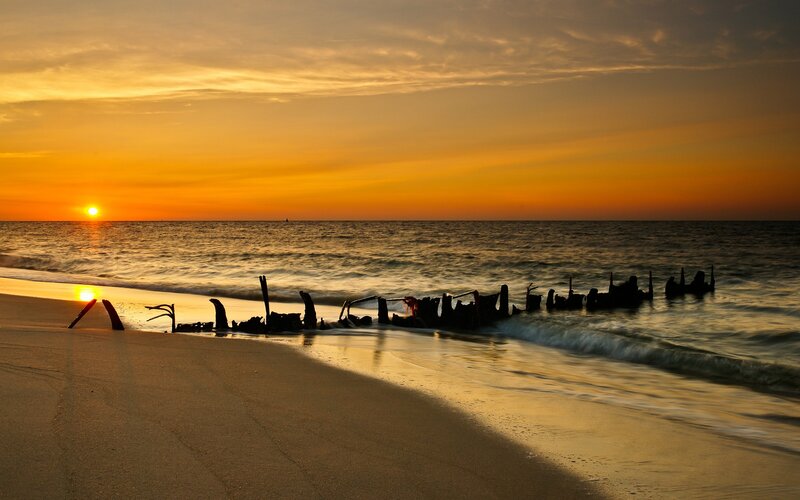 Shipwreck on Beach — Orange, Serene, Sunset, Photograph, Sun, Ocean