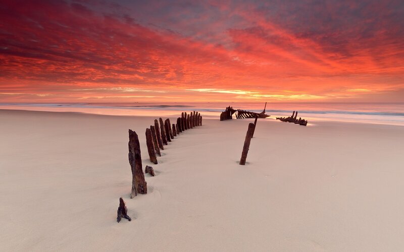 Shipwreck on Beach — Red, Dramatic, Sunset, Photograph