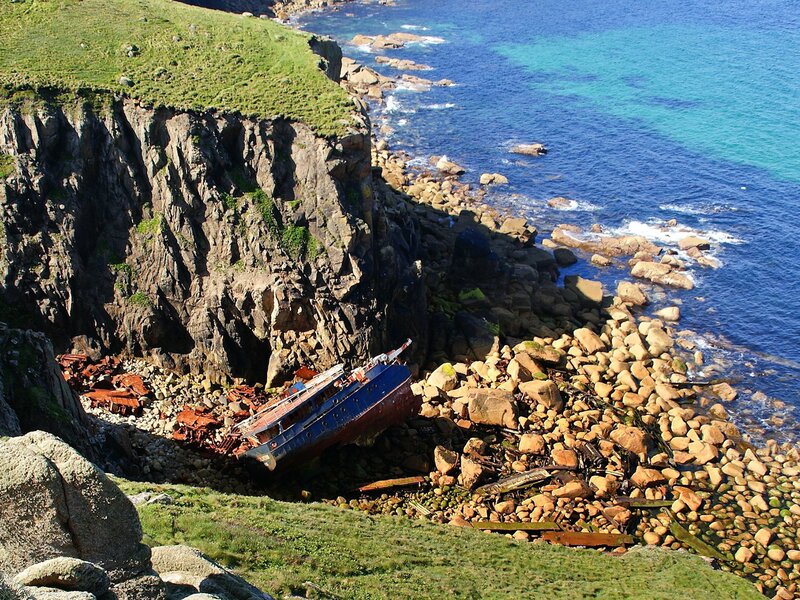 Shipwreck on Rocky Shore — Blue, Dramatic, Afternoon