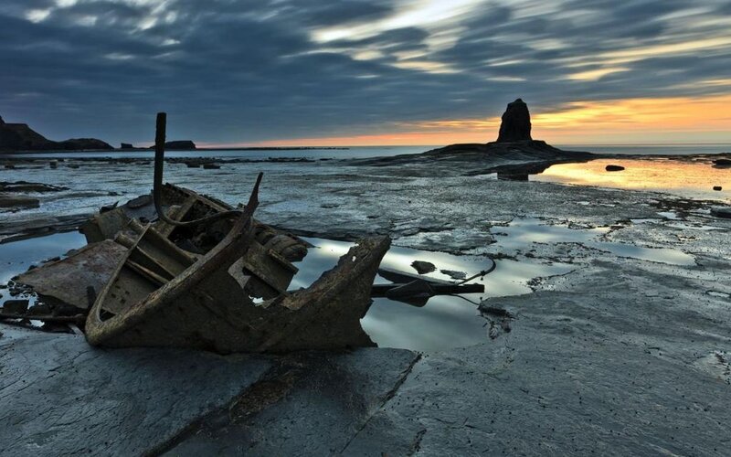 Shipwreck on Rocky Shore — Gray, Dramatic, Sunset