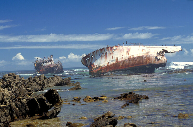 Shipwrecked vessels on rocky shore