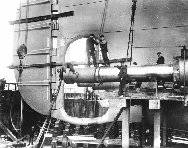 Shipyard workers installing a cannon