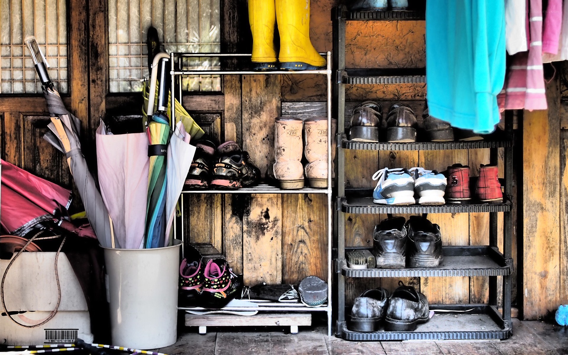 Shoe rack with umbrellas and boots