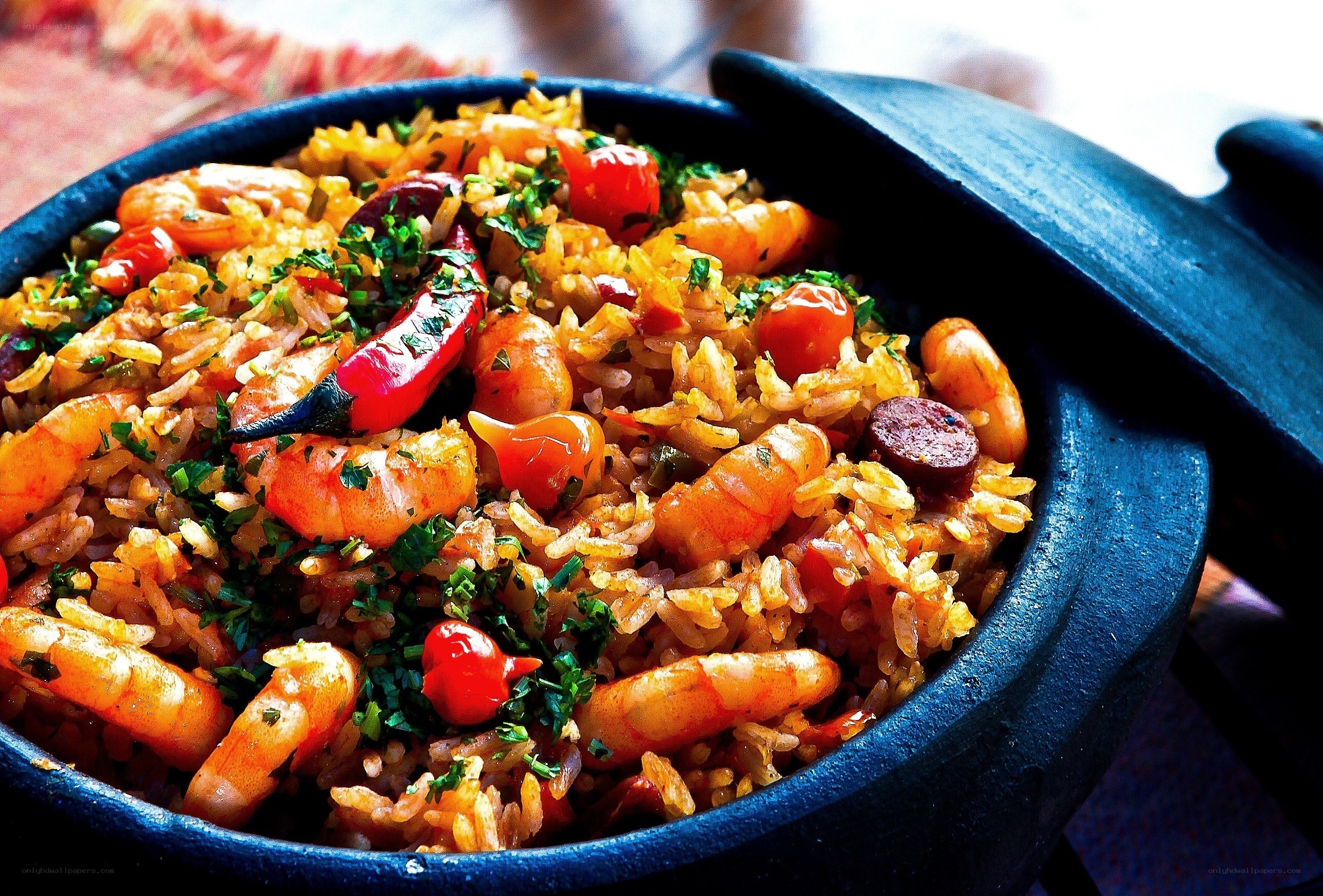 Shrimp paella in a clay pot