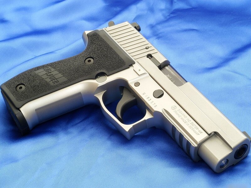 Sig Sauer pistol on blue cloth