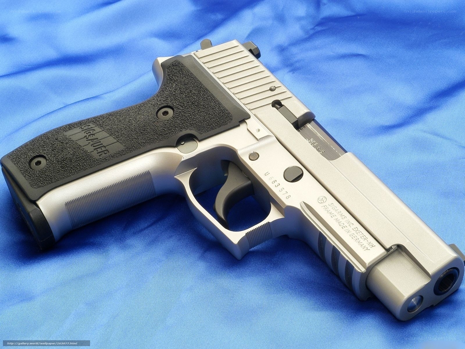 Sig Sauer pistol on blue cloth