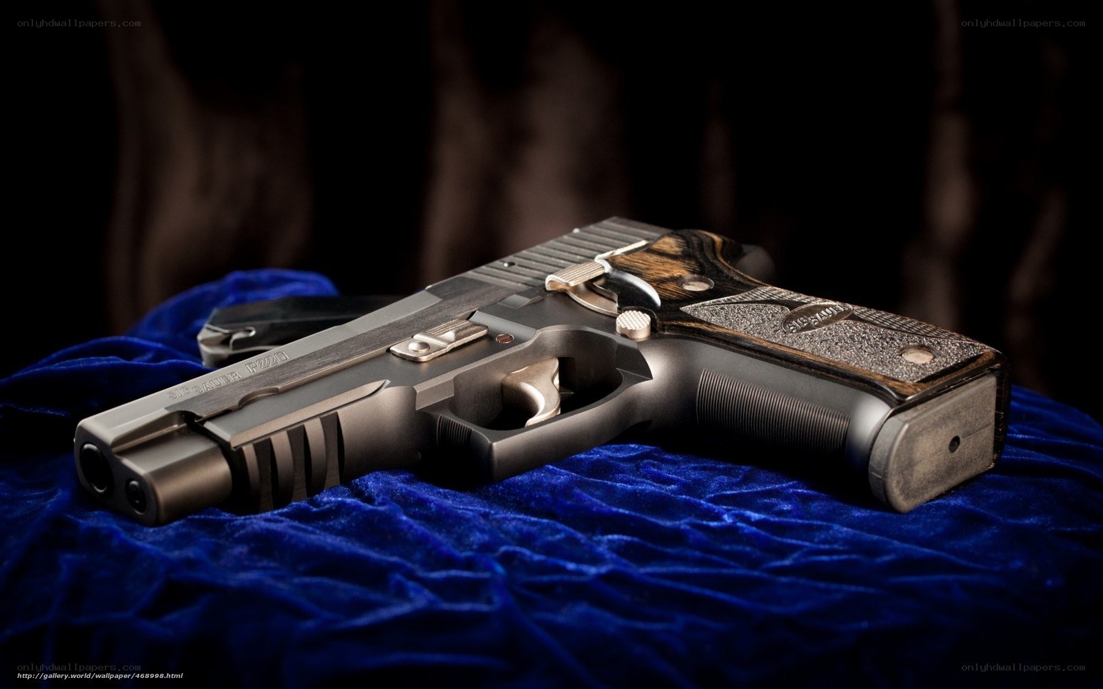 Sig Sauer pistol on blue velvet