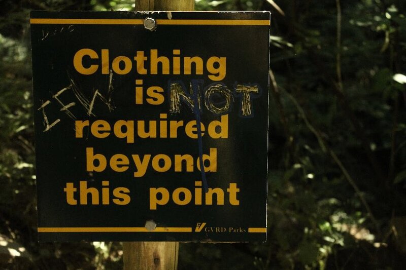 Sign indicating no clothing required
