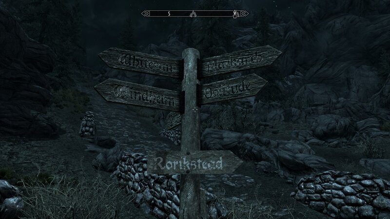 signpost in dark forest