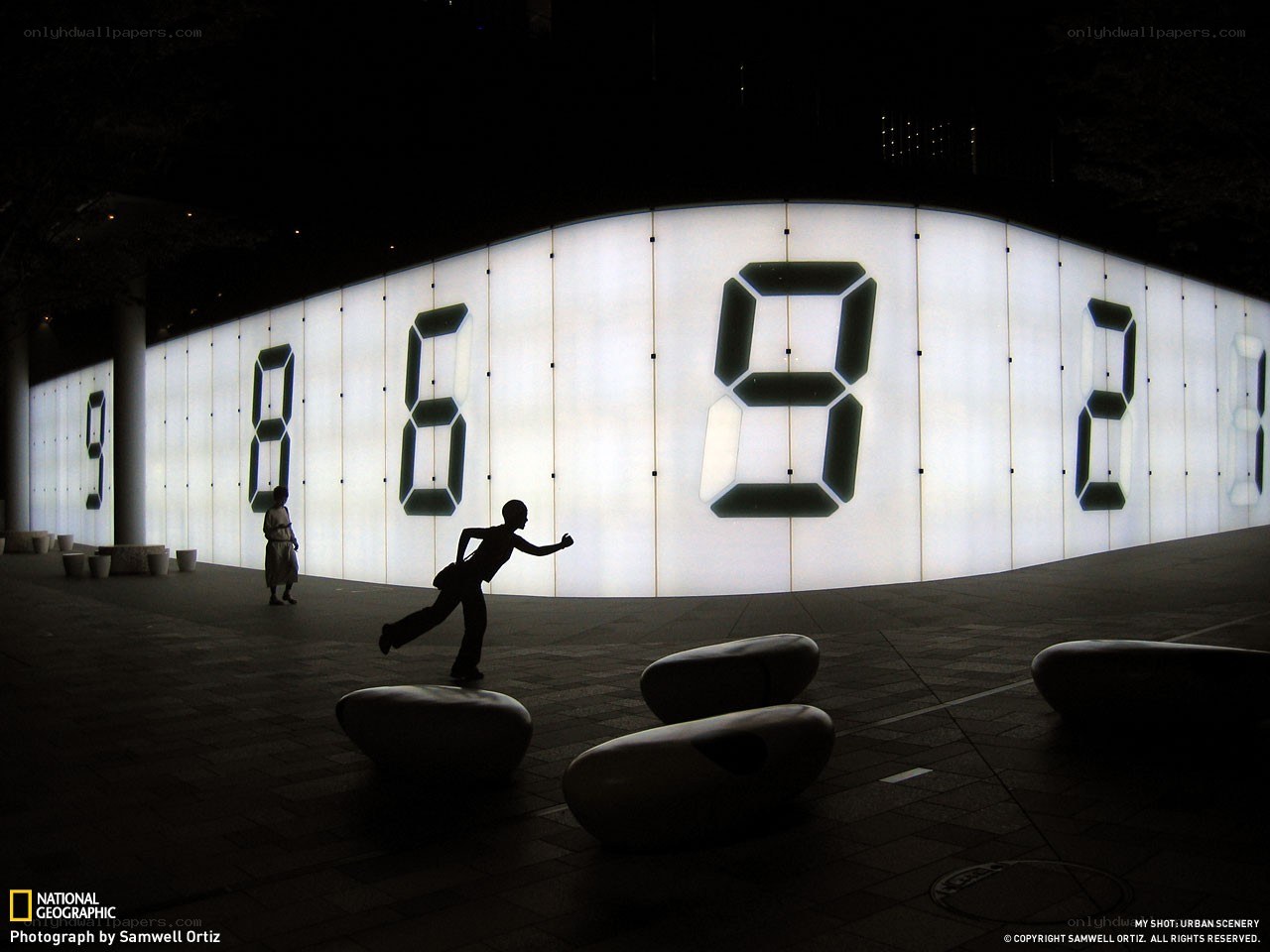 Silhouette at digital clock