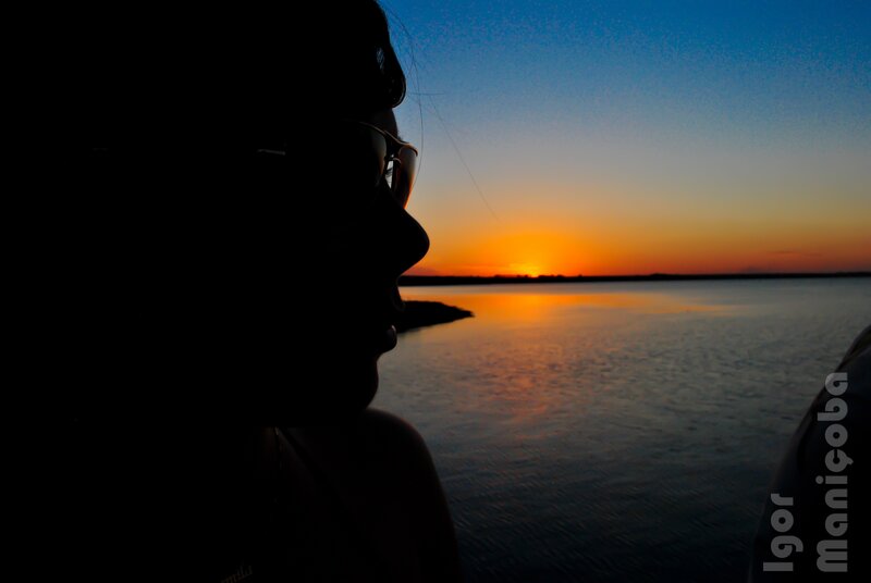 Silhouette at sunset by the water