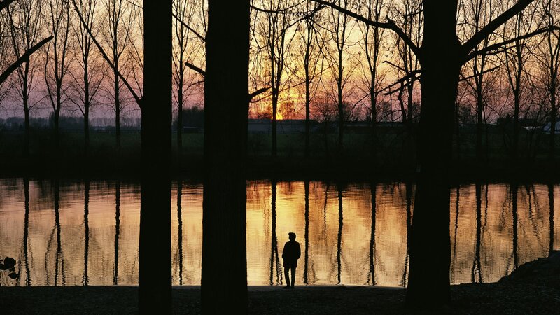 Silhouette at sunset by the water