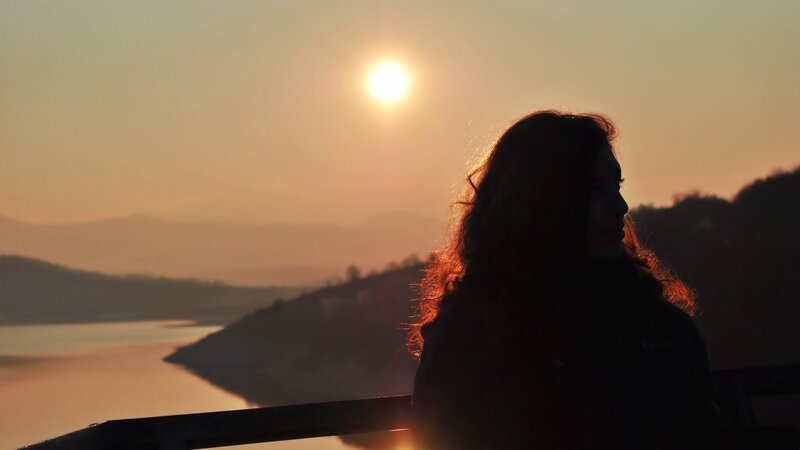 Silhouette at sunset by the water
