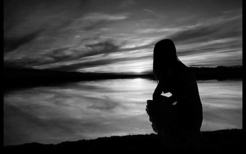 Silhouette at sunset by the water