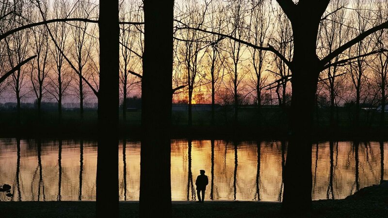 Silhouette at sunset by the water