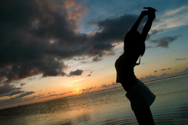 Silhouette at sunset by the water