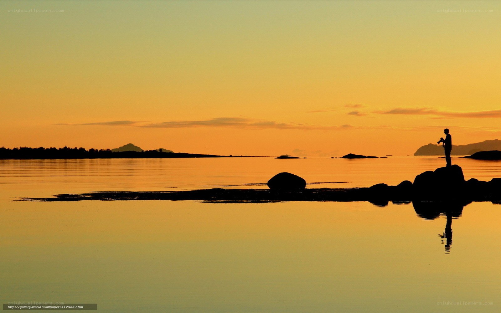 Silhouette at sunset by the water