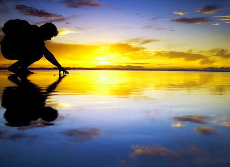 Silhouette at sunset by water