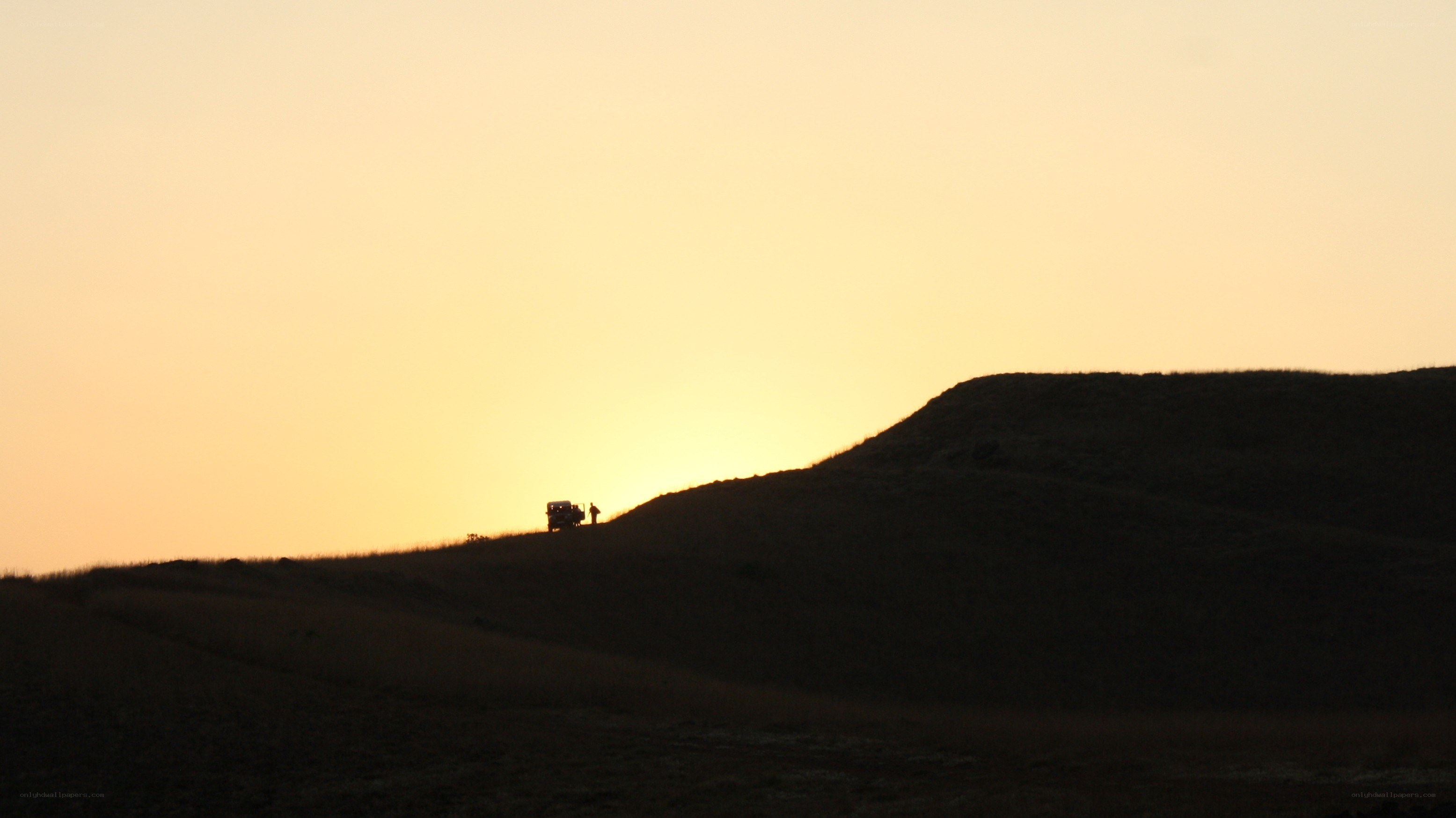 Silhouette at sunset on a hill