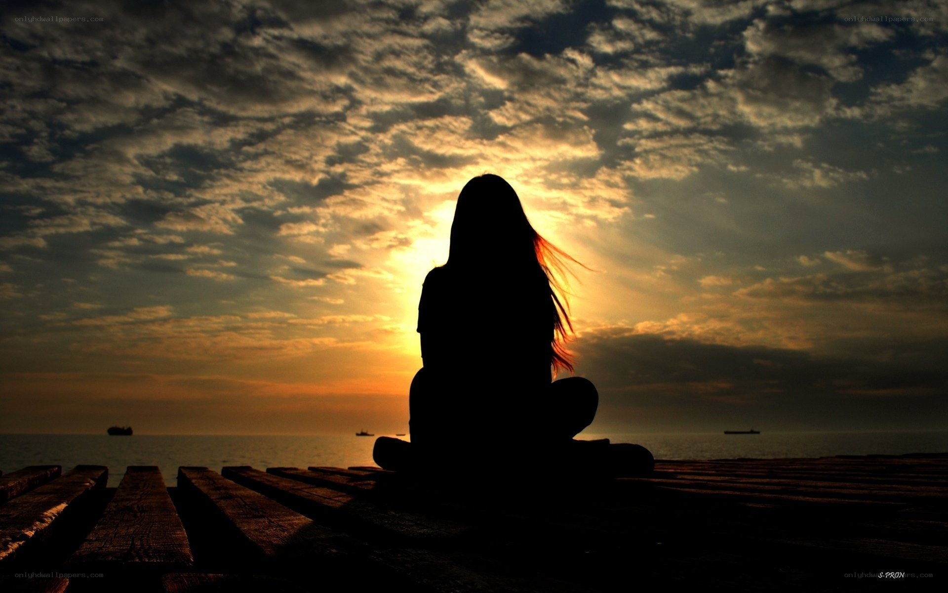 Silhouette at sunset on a pier