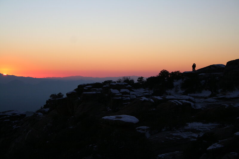 Silhouette at sunset on a rocky hill