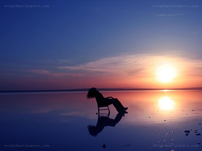Silhouette at sunset on water