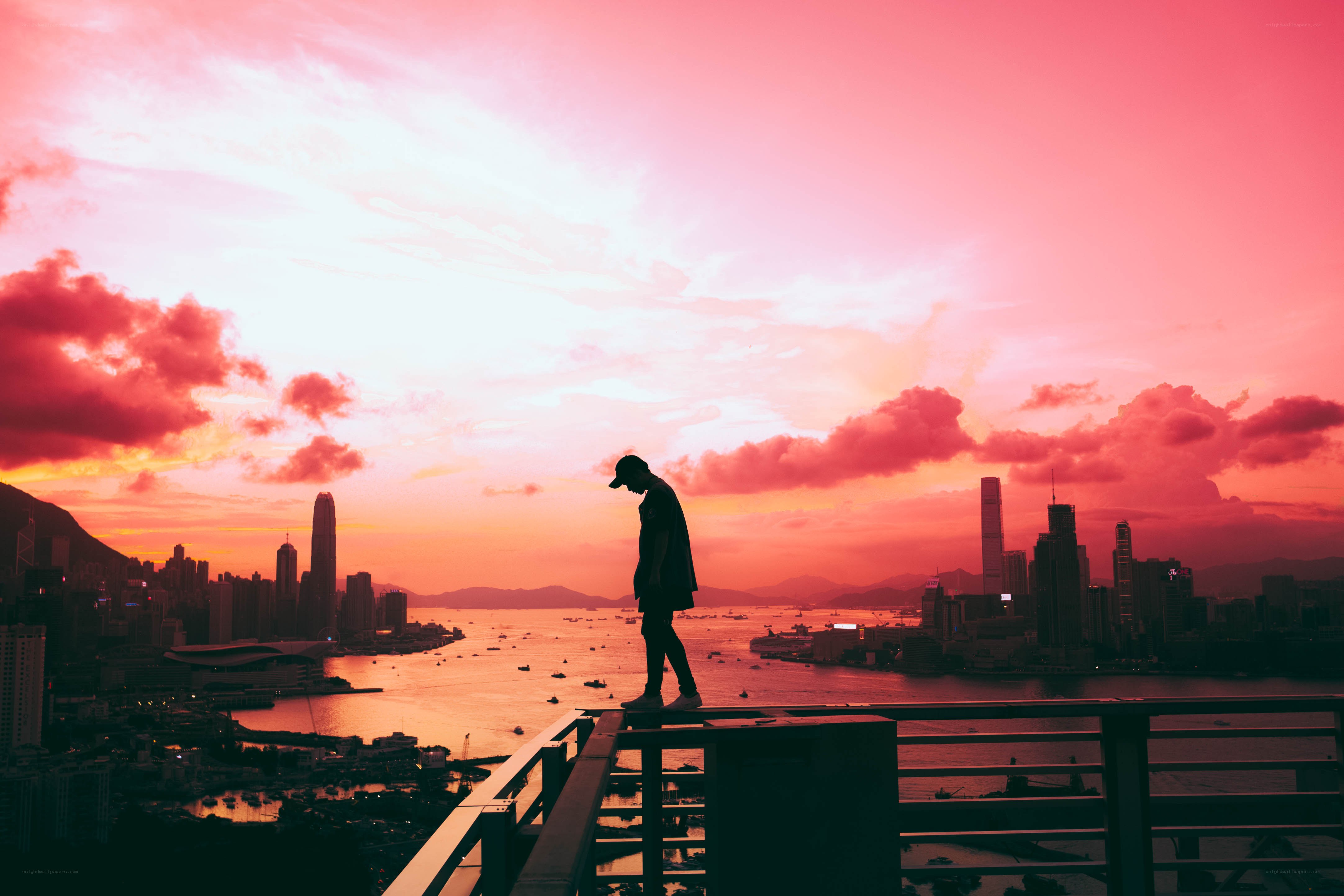 Silhouette at sunset over city