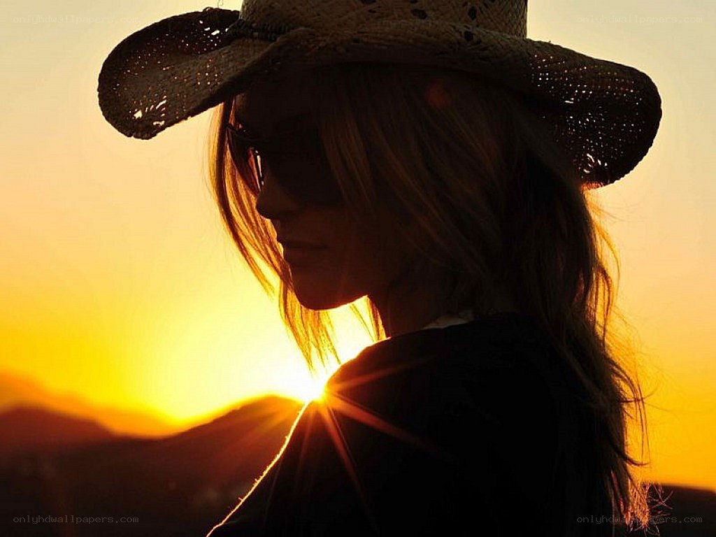 silhouette at sunset with cowboy hat