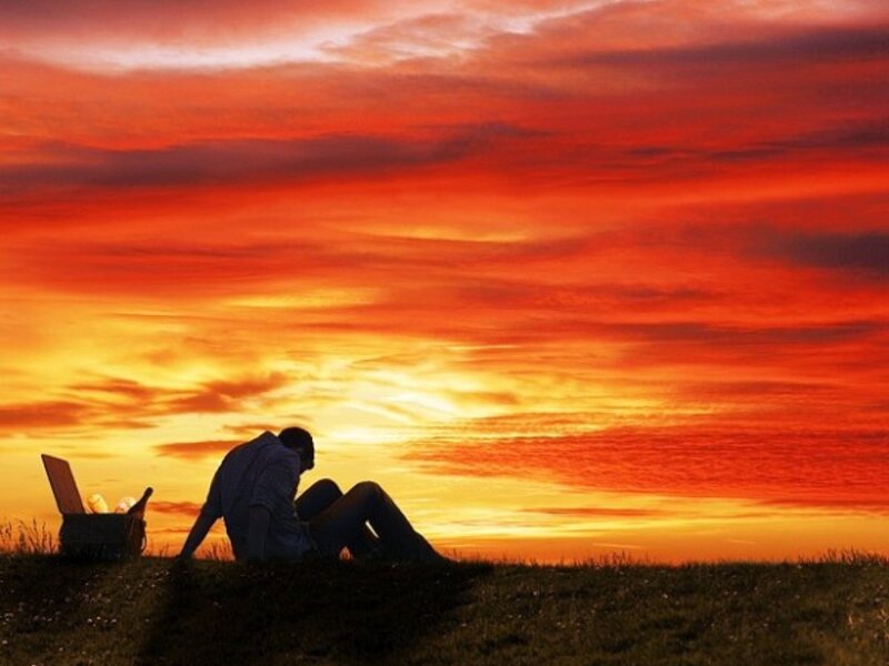Silhouette at sunset with picnic basket