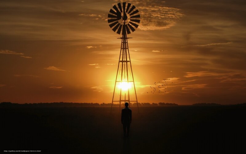 Silhouette at sunset with windmill