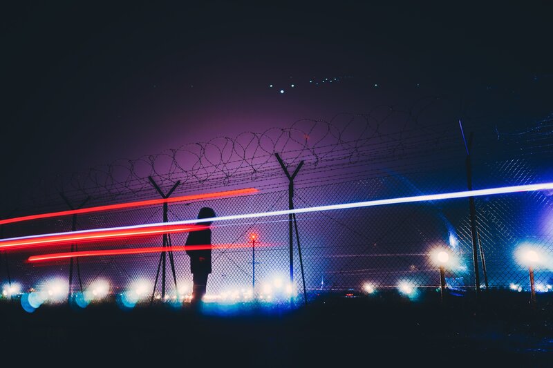Silhouette Behind Fence